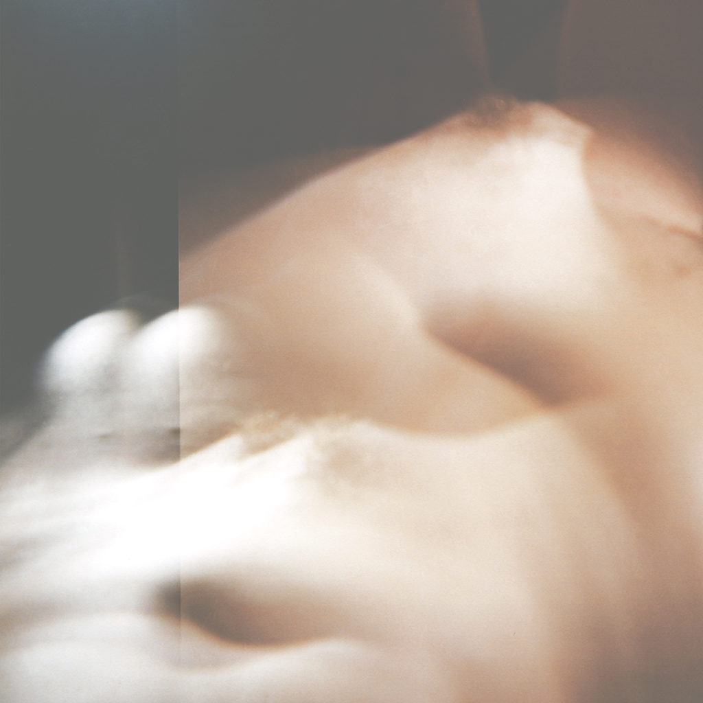 Image description: Indistinct body parts are transposed in multiple exposures causing them to blur. The shapes for a kind of peak as the left slope shifts into a black and white exposure.